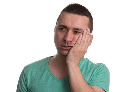 Young man with tooth ache