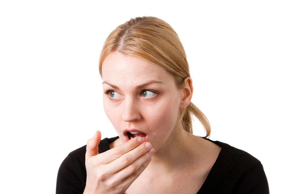 Woman checking for bad breath