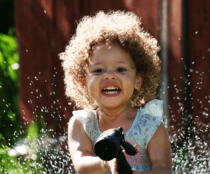 Smiling Baby Birl Playing with Water