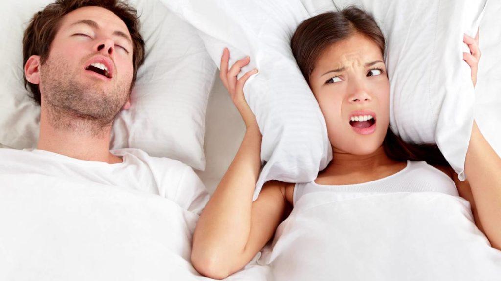 Couple Sleeping wife upset bcause she cannot sleep because her husband is snoring