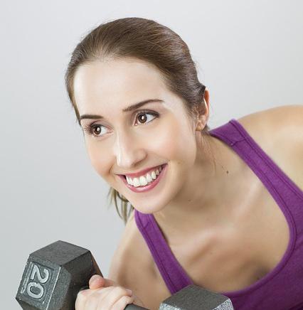 Smiling Woman lifting Weights