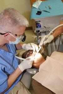 Dentist workin on a man's teeth