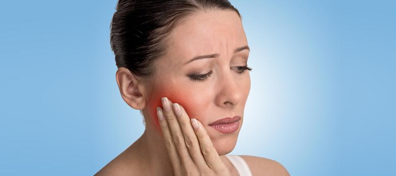 Women with painful dental emergency.