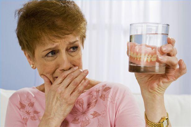 Older woman having denture pain