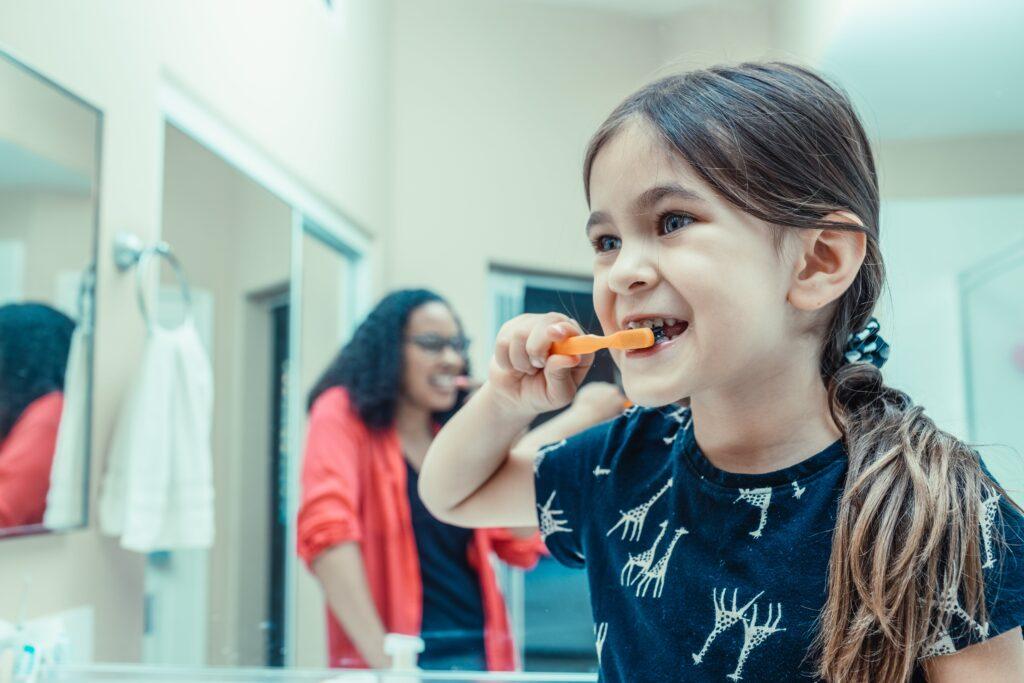 Child brushing her teeth