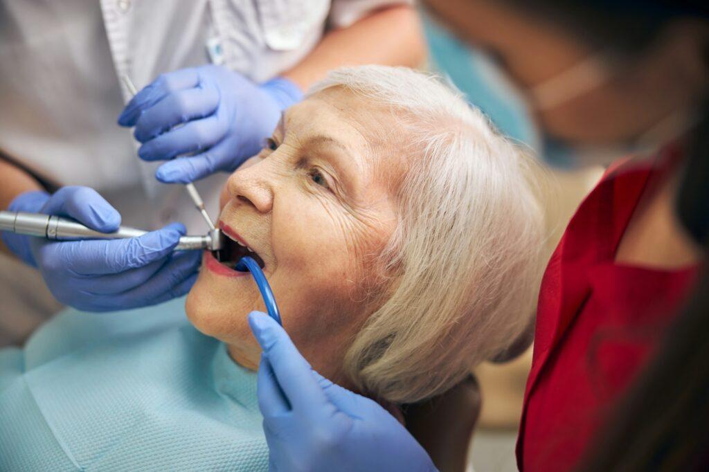 Doctor with assistant and patient in the dental clinic