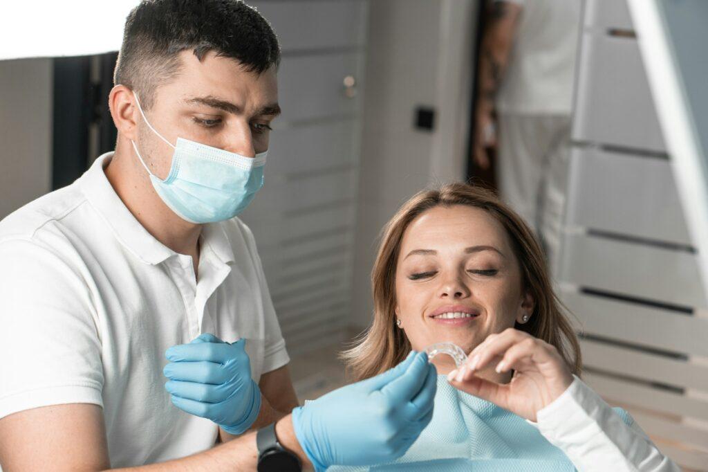 Dentist holds aligner aligner in hands, preparing for important stage treatment and providing