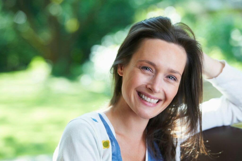 Smiling woman sitting outdoors