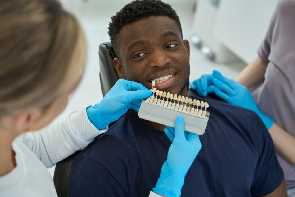 Nurse chooses veneers for male in the clinic