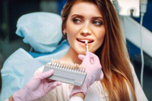 Young woman at the dentist's chair during a dental procedure. Overview of dental caries prevention.