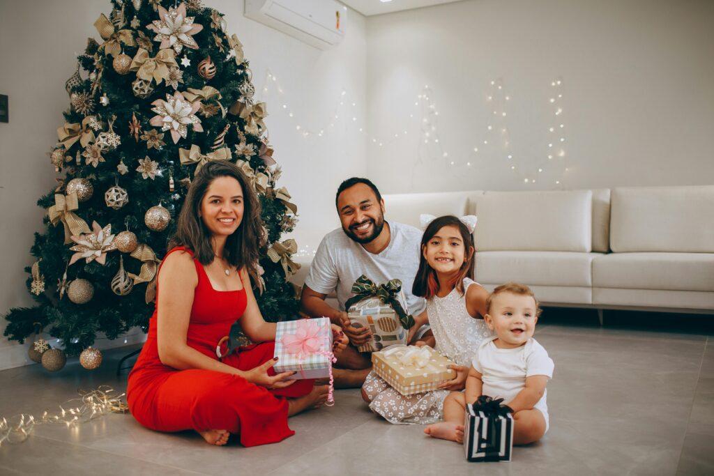 Smiling family exchanging Christmas gifts