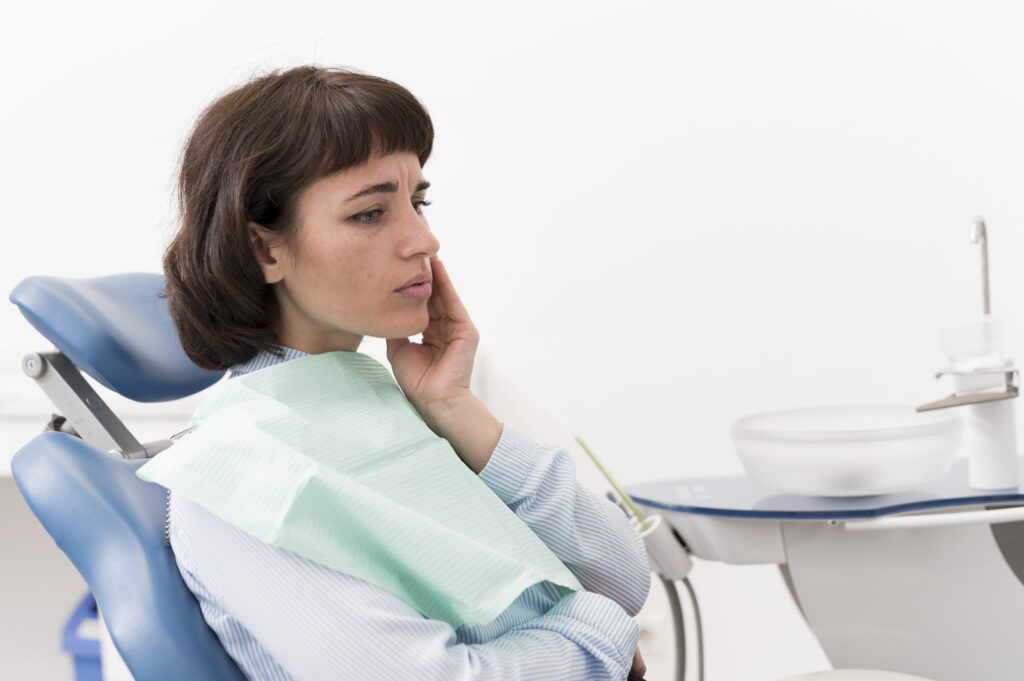 female-patient-having-toothache-dentist-s-office