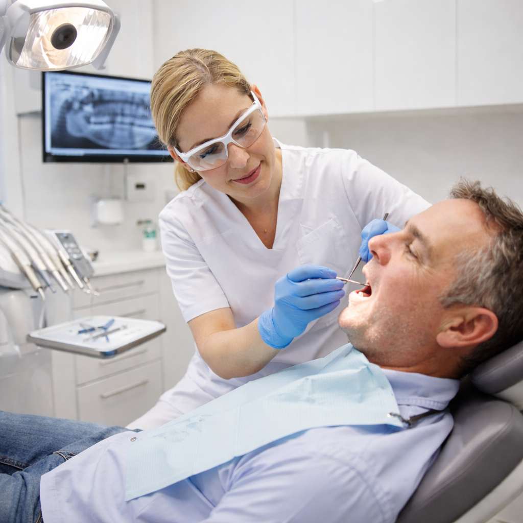 An emergency dentist in Orem Utah evaluating a patient with a dental emergency during a same-day urgent care appointment