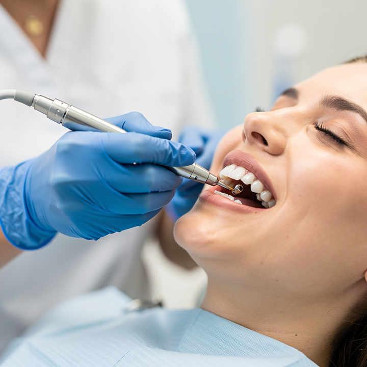 Dental hygienist performing a scaling and root planing deep cleaning in Orem, Utah