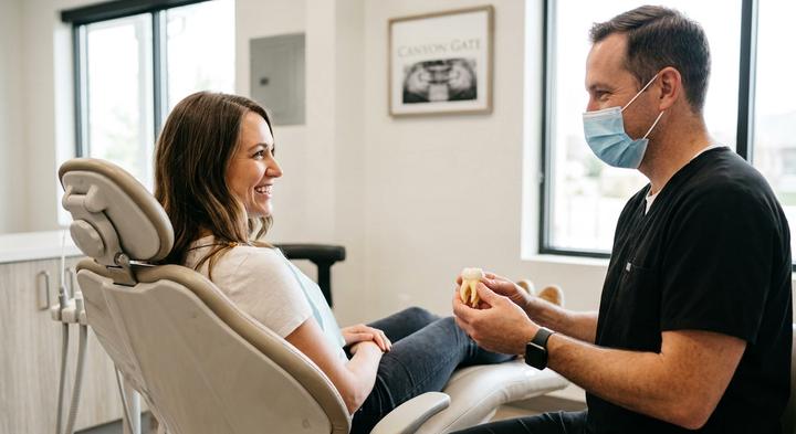Dentist discussing a dental model with a patient during a consultation